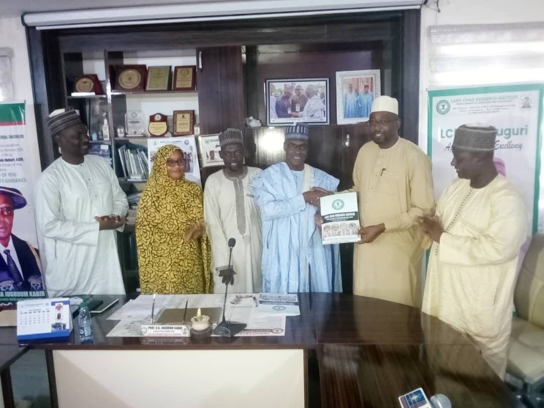 Participants presenting an institutional document during the engagement at Lake Chad Research Institute, Maiduguri.